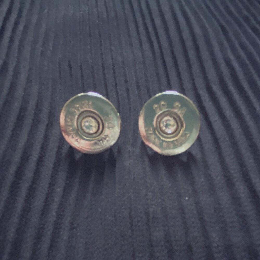 Silver-toned shotgun shell earrings with cubic zirconia stud in the center.